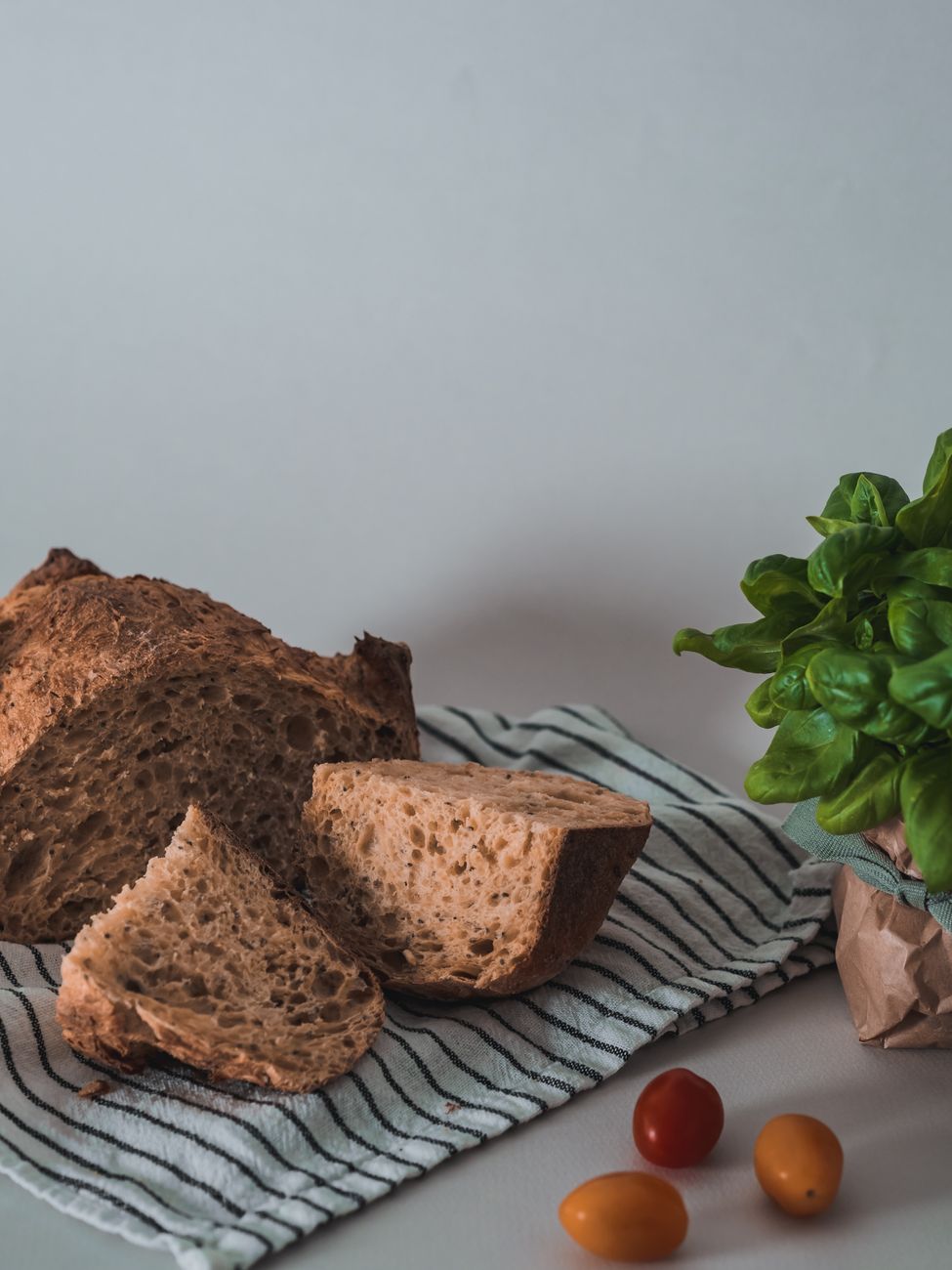 Rustic table setting with wild herbs and fresh bread