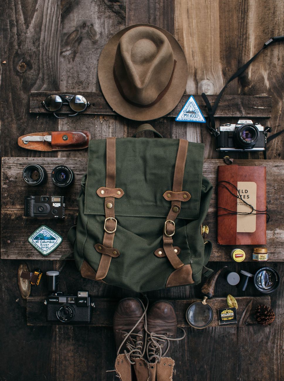 Neatly folded wool garments and notebook ready for travel