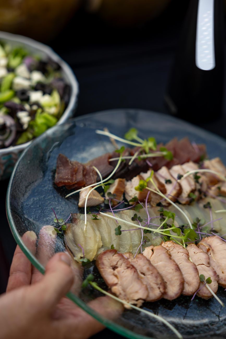 Chef plating fresh farm-to-table cuisine outdoors